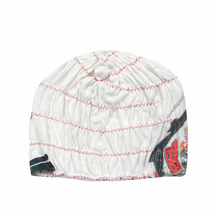 White beanie with red and black patterns on a white background