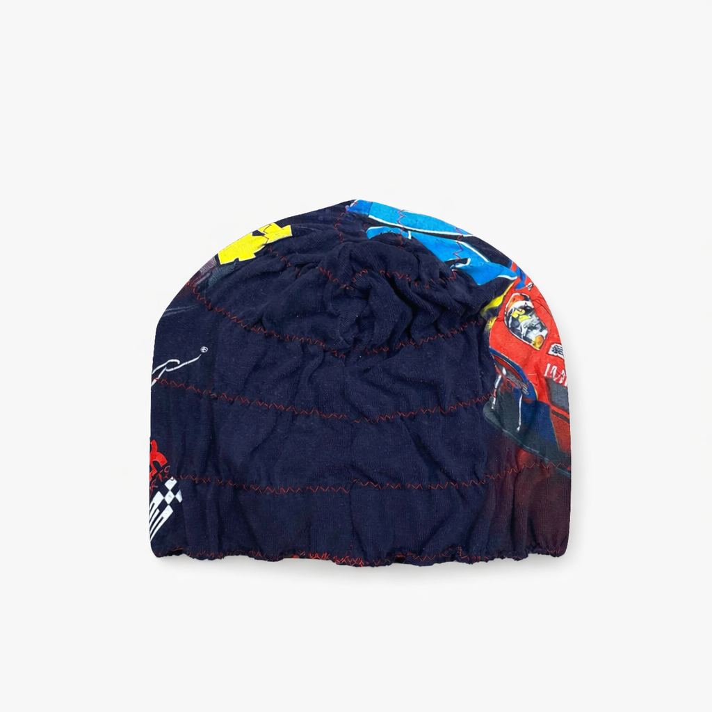 Navy blue baby bloomers with colorful car pattern on a white background