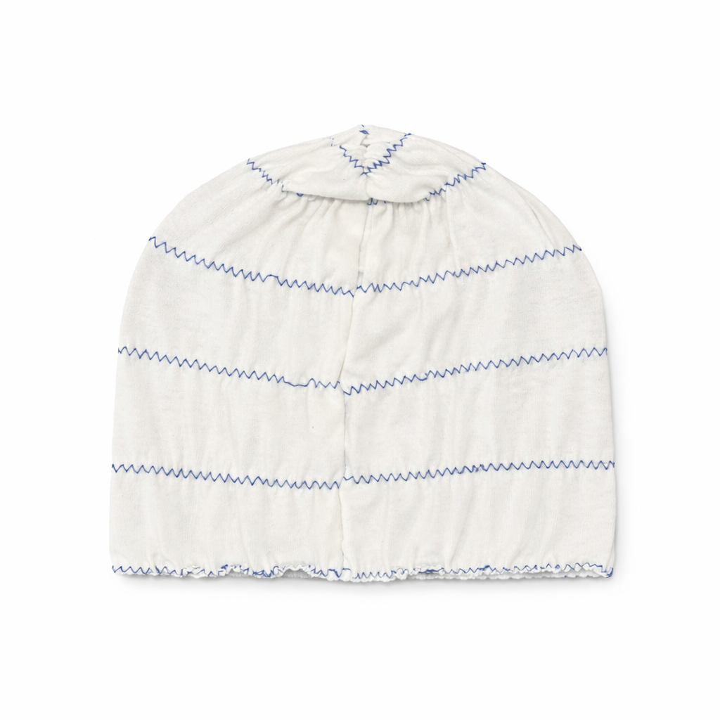 White beanie with blue stripes on a white background