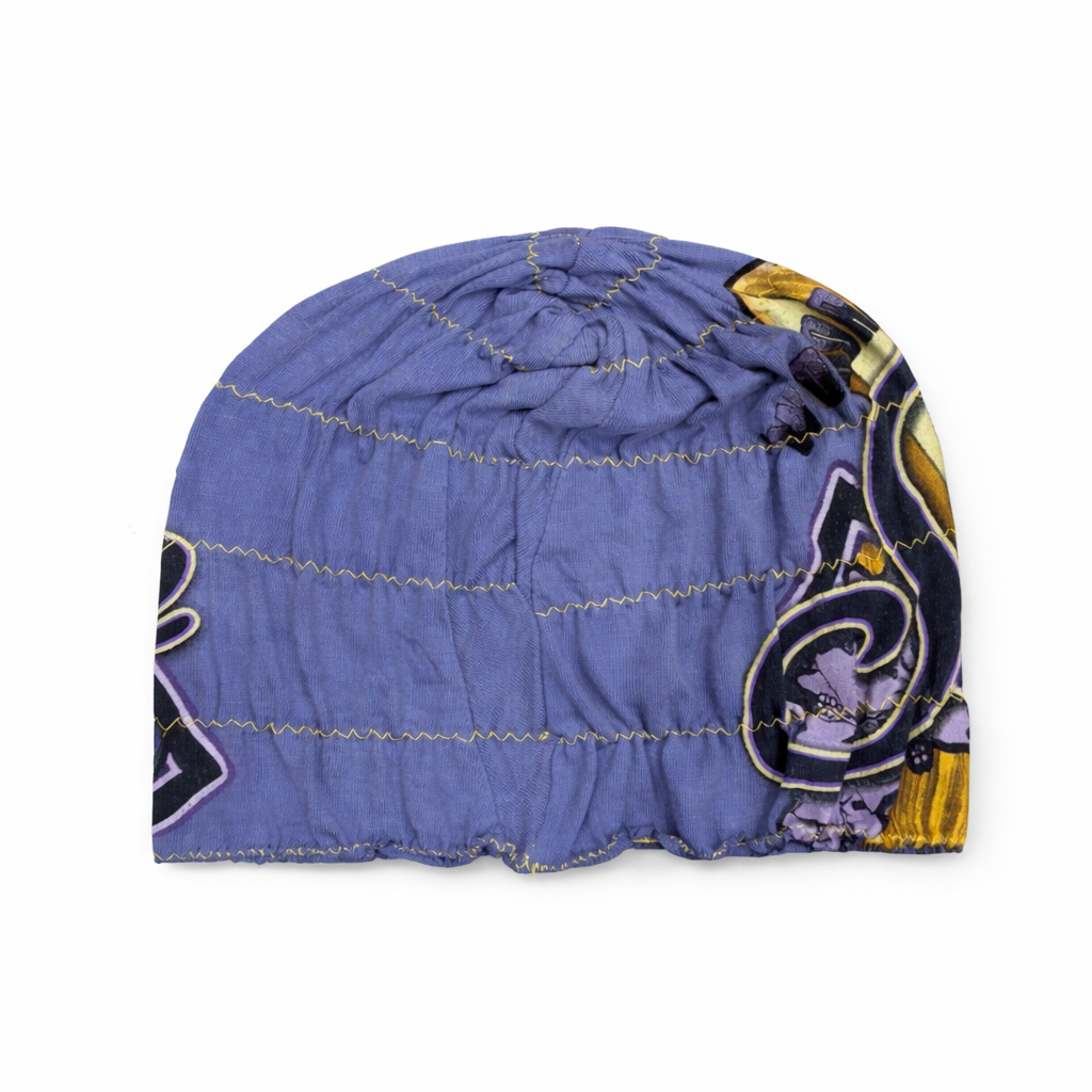 Blue quilted beanie with a pattern on a white background