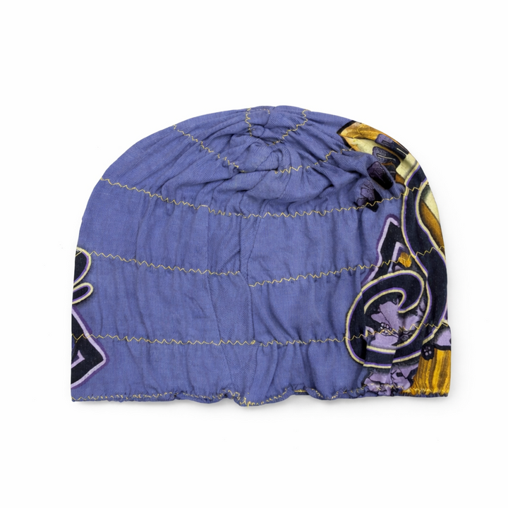Blue quilted beanie with a pattern on a white background