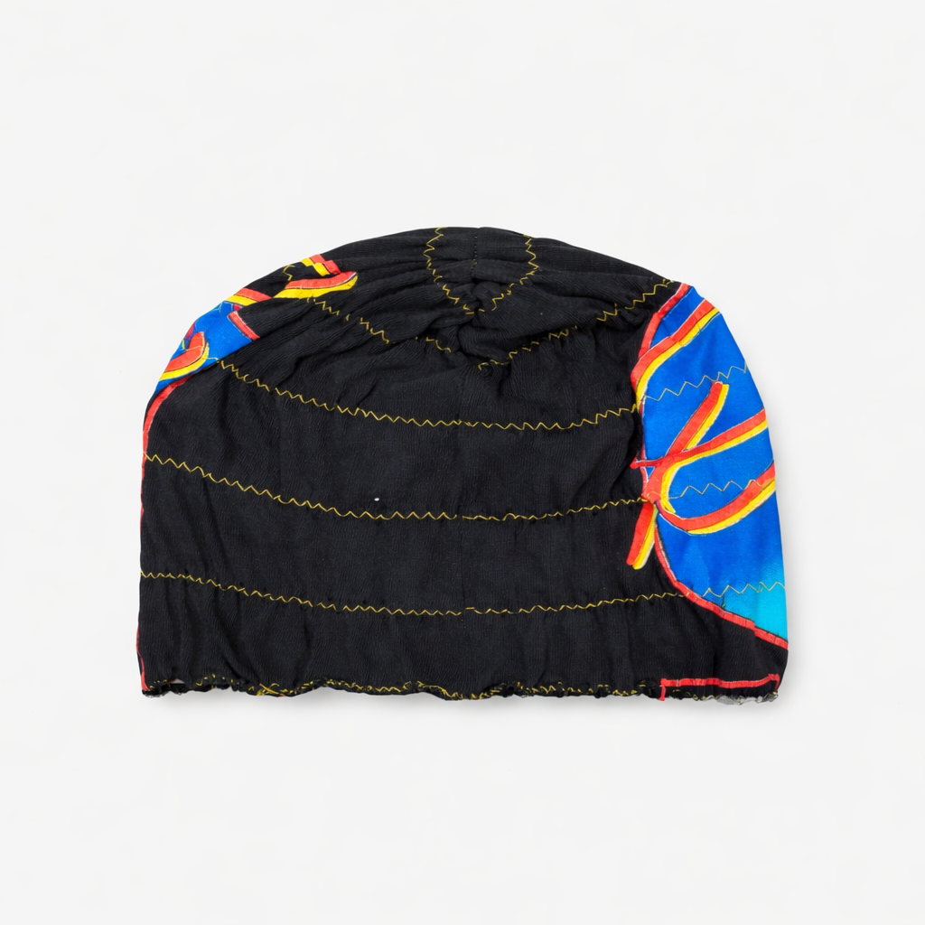 Black beanie with colorful flame pattern on a white background